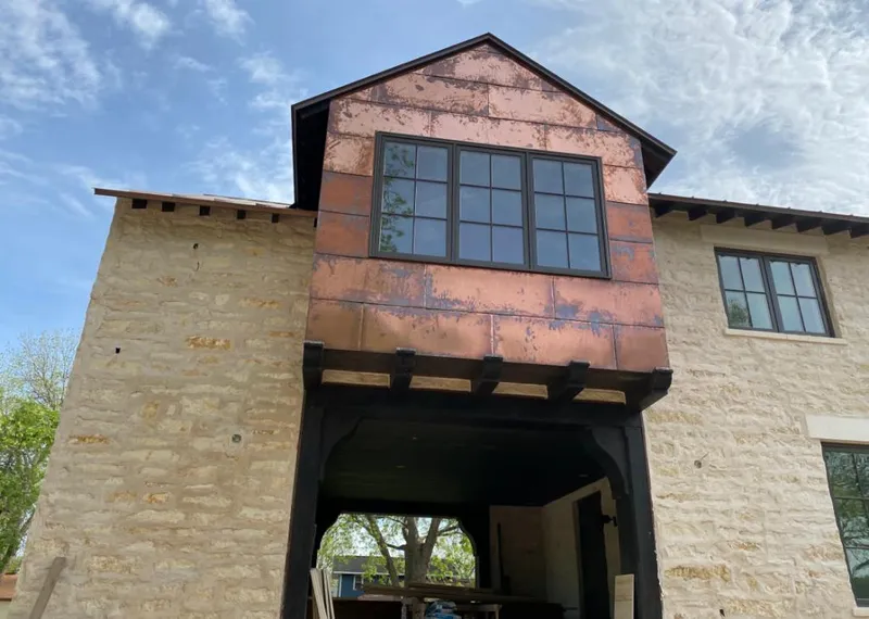 Copper metal panel facade on a stone building for Skylight Installation in Terrytown